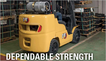 Man Using a Cat Cushion Tire Internal Combustion Forklift to Lift a Load
